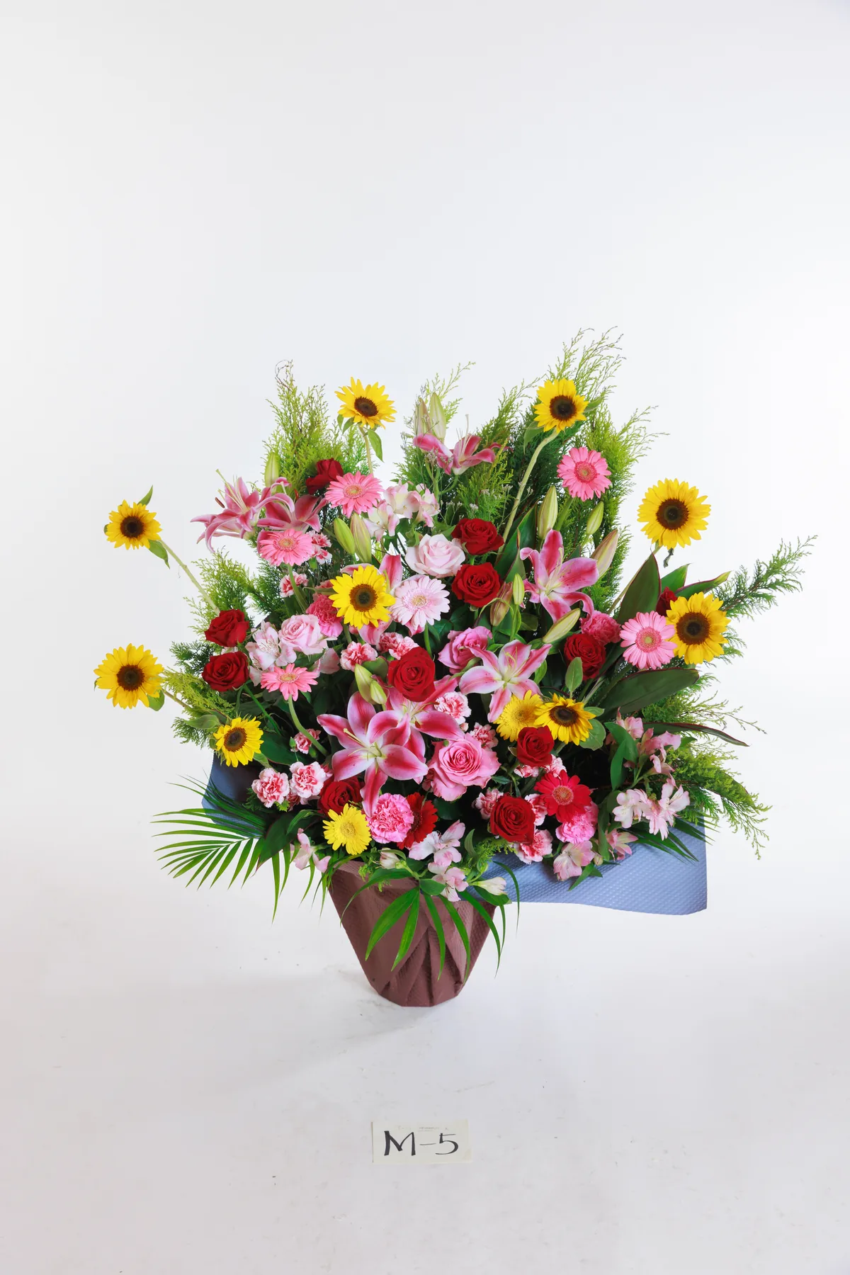 ひまわりやピンクの花を合わせた門出祝いのアレンジ